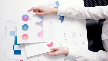 Horizontal video: A woman is looking at the chart graph and statistic report 5726130. Duration: 9 seconds. Resolution: 3840x2160