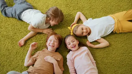 Horizontal video: Children lying down on the floor 8088627. Duration: 15 seconds. Resolution: 3840x2160