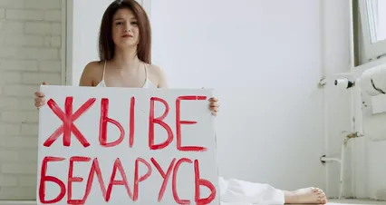 Horizontal video: A woman crying while holding a placard 8561360. Duration: 15 seconds. Resolution: 4096x2160