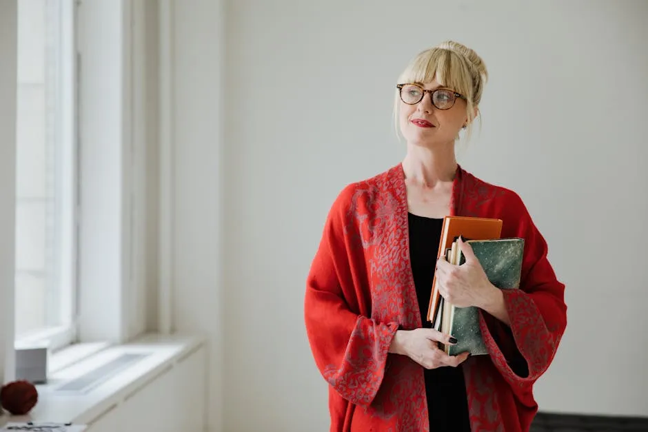 A Woman in Red Cardigan Holding Books